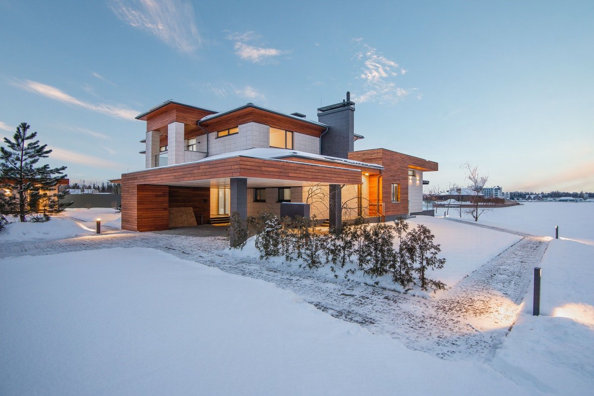 modern house with lights on amidst the sun's bright lighting